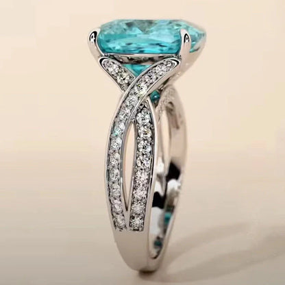 Adjustable women's ring with 4mm square blue zircon stone on silver-tone band