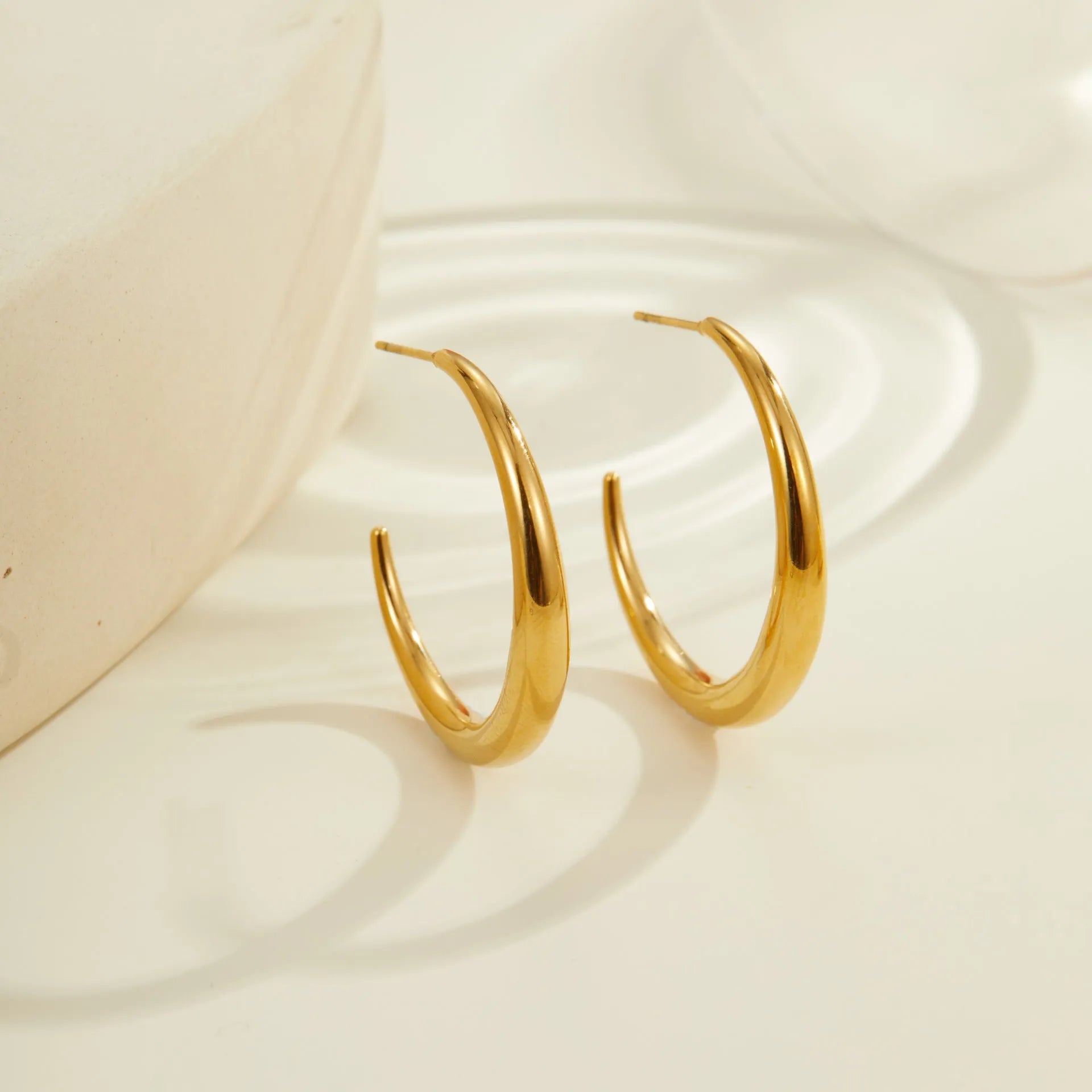 Women's stainless steel hoop earrings in two sizes with gold or steel finish