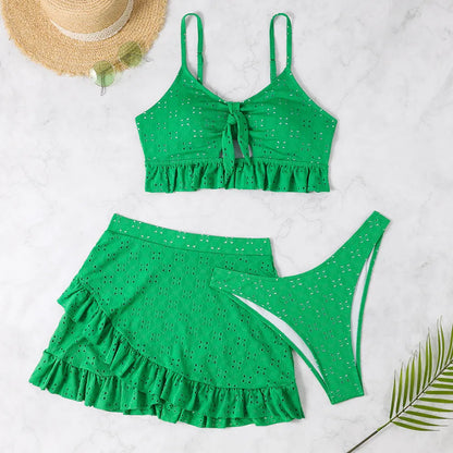 Women's white split hip skirt three-piece bikini swimsuit set on a mannequin.