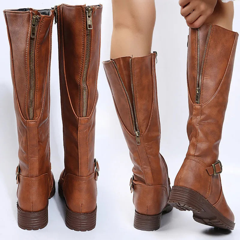 Women's black high knight boots with a square heel, round toe, and ankle buckle detail.