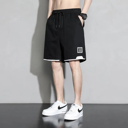 Cotton shorts for teenage boys in black, shown on a hanger, featuring a mid-waist design.