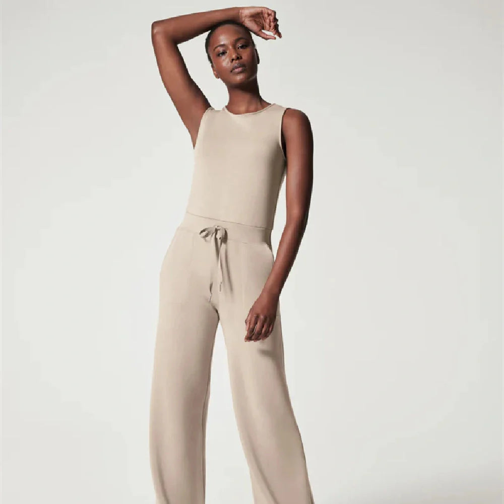 Women's lace-up jumpsuit pants in polyester, available in multiple colors and sizes for adjustable fit.