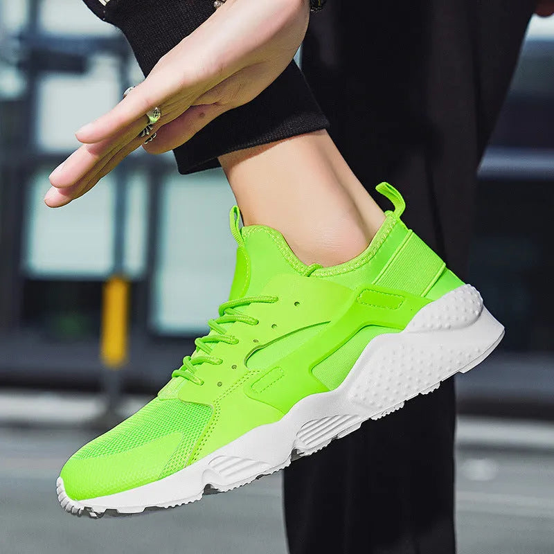 Men's low top casual shoes in mesh with round toe design and flat heel for leisure wear, available in fluorescent red, green and yellow colours, featuring cross shoulder straps and front lace-up fastening with MD sole in sizes 40 to 47