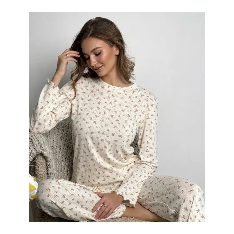 White floral print women's loungewear set with bell sleeve top and wide-leg trousers laid flat.