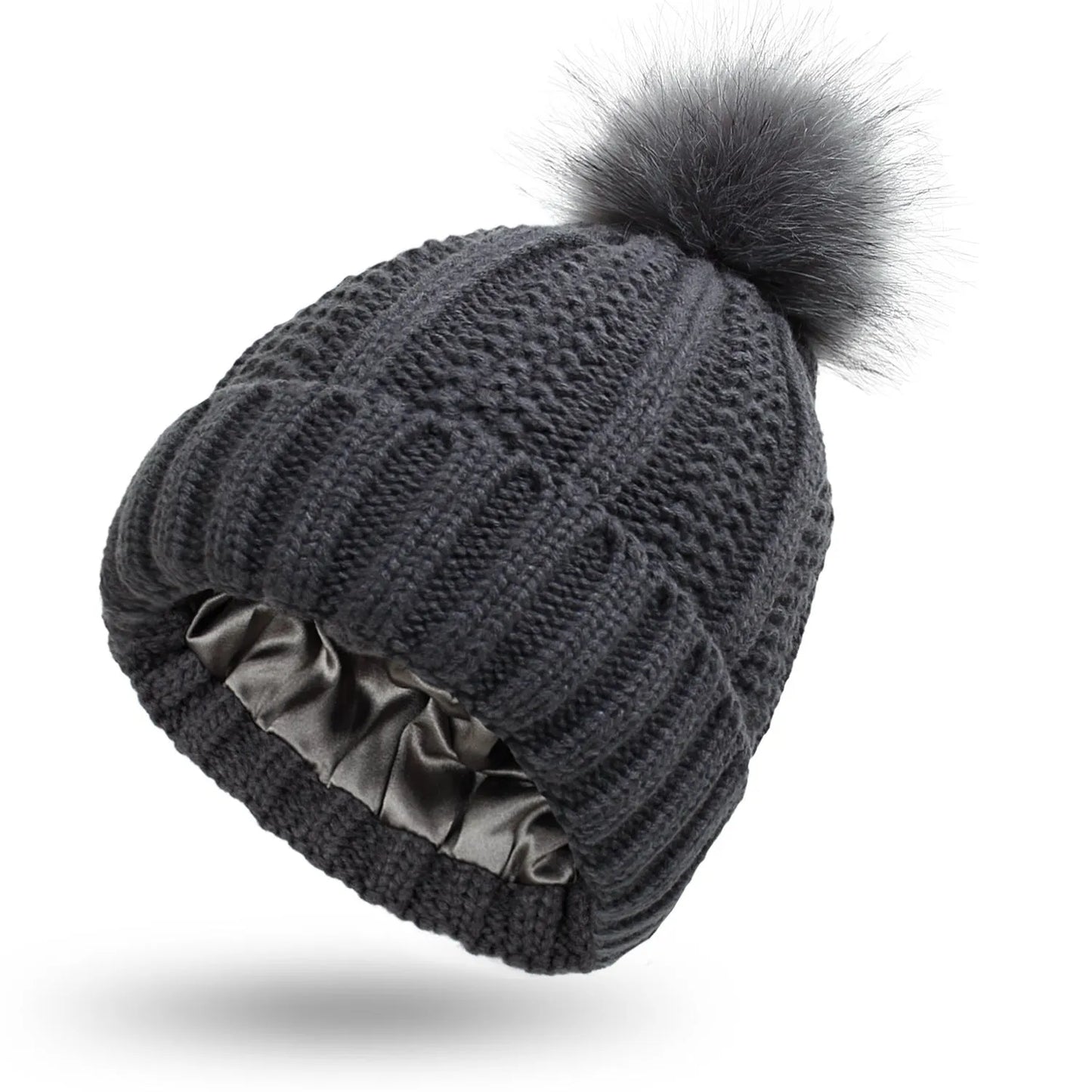 Wool knit beanie hat for women with faux fur pom pom and satin lining, shown in a wine red colour.