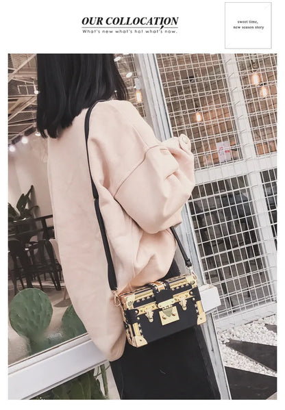 Women's hard flap shoulder bag in black or green with single adjustable strap and rivet decoration