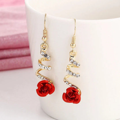 Ethnic red rose drop earrings with big rhinestones in rose gold spiral design