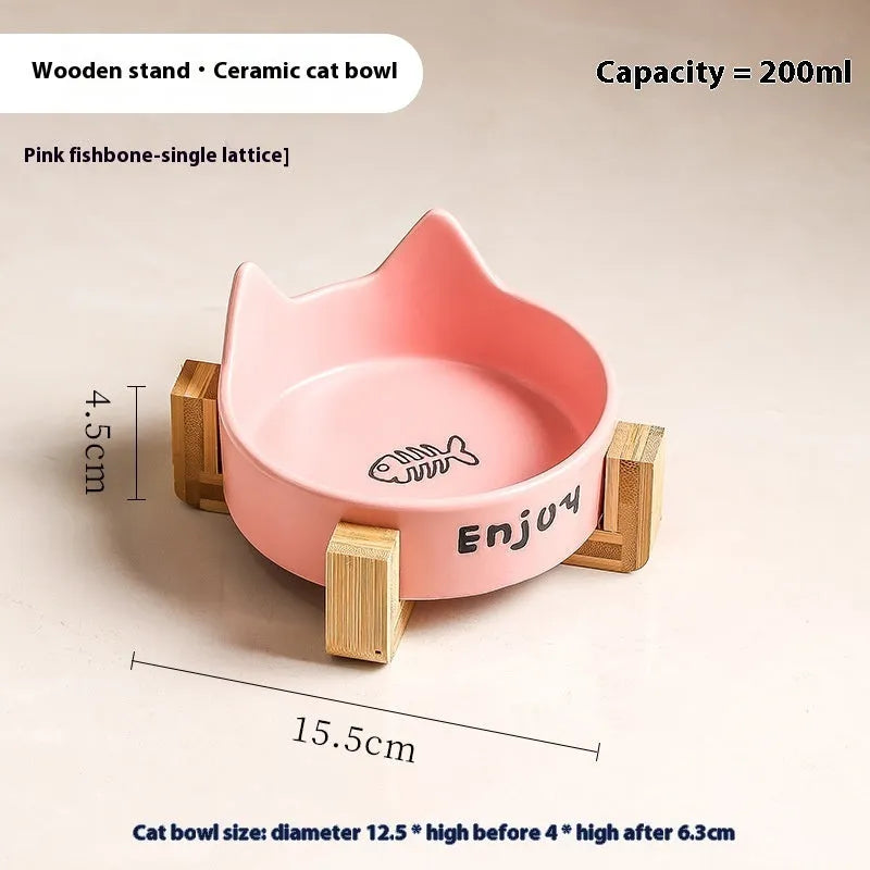 Porcelain cat bowl with anti-tumble wooden frame in pink with a cat paw design