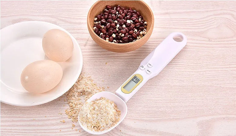 Black electronic measuring spoon scale showing digital display with spoon bowl for kitchen weighing