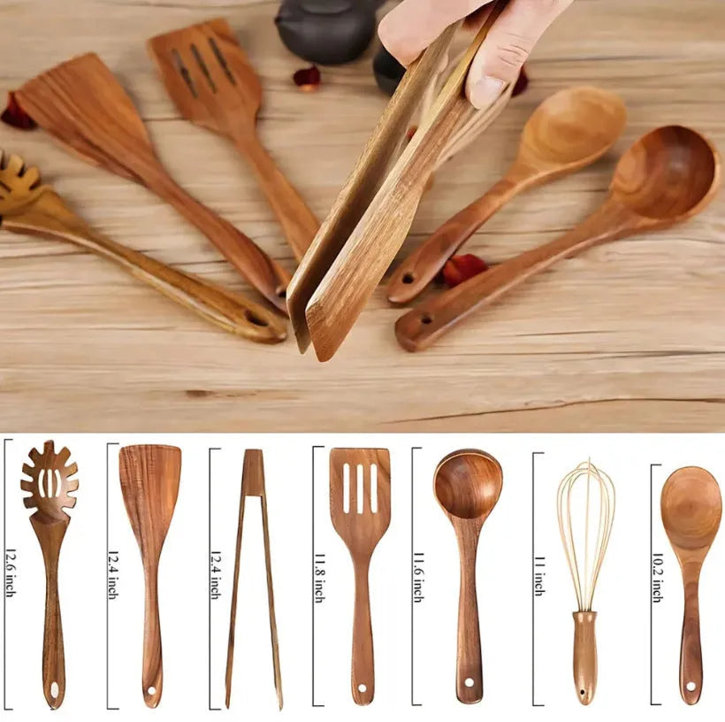 Set of seven light brown wooden cooking utensils including spoons, spatula, and turner on a kitchen counter.