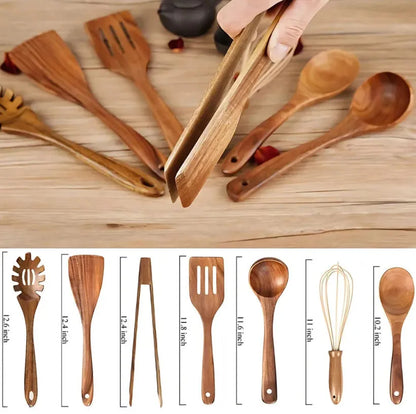Set of seven light brown wooden cooking utensils including spoons, spatula, and turner on a kitchen counter.
