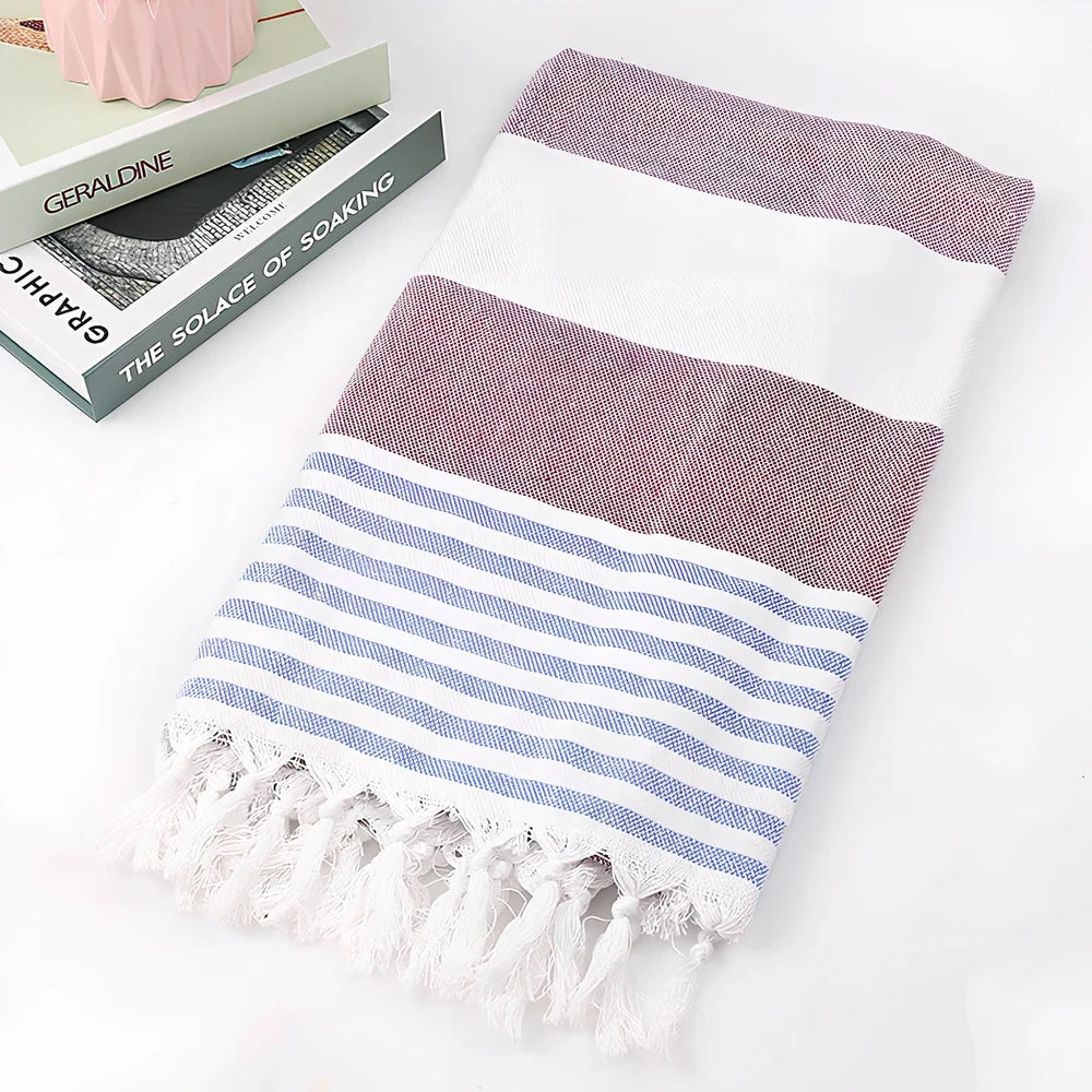 Striped Turkish beach towel showing blue and white pattern, measuring 100cm by 180cm