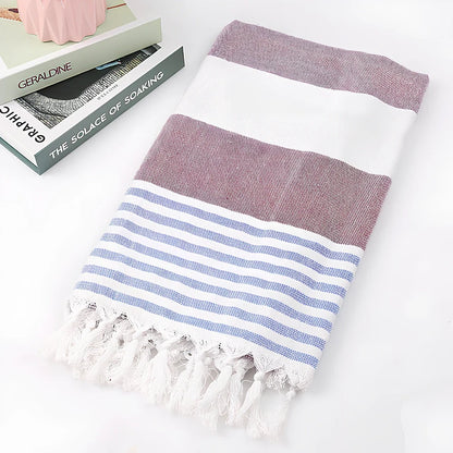 Striped Turkish beach towel showing blue and white pattern, measuring 100cm by 180cm