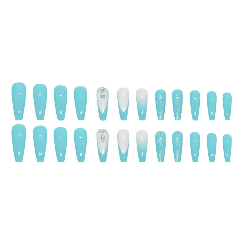 Solid blue glitter ballet-style artificial nail patches and glue bottle arranged on a table.