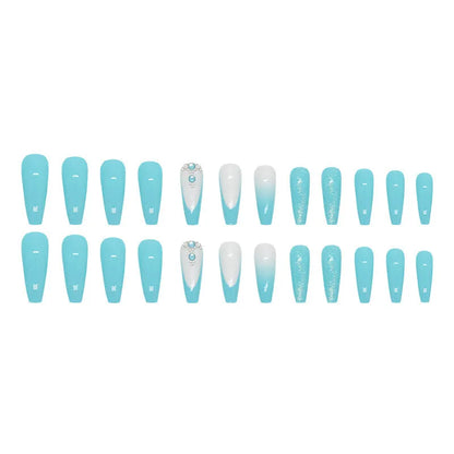 Solid blue glitter ballet-style artificial nail patches and glue bottle arranged on a table.