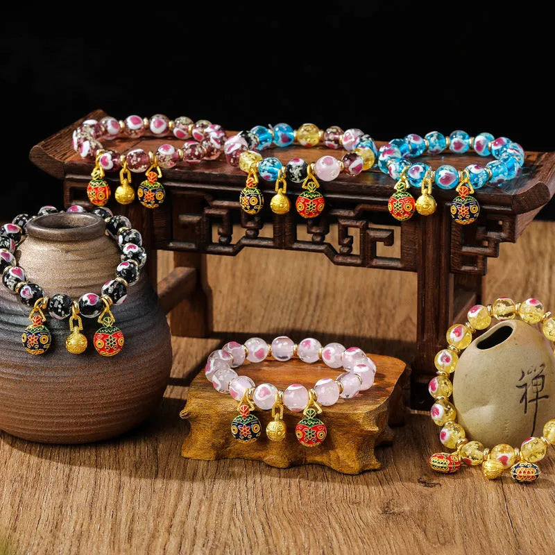 Heart-shaped handmade glass bracelet featuring ancient fluorescent glaze with 10mm swallowing gold beast cherry blossom charm, available in Duobao, Hulan, gold, black, pink and purple colours for unisex wear.