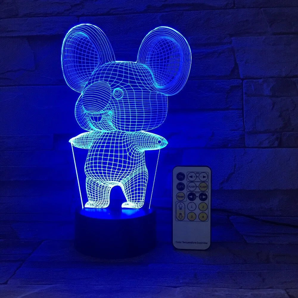 Black Koala night light with LED illumination on a bedside table.