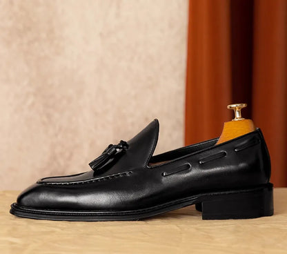Men's black genuine leather slip-on loafers with polished finish and rubber sole