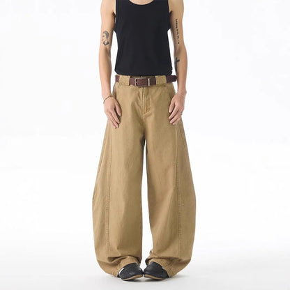 Brown men's loose fit straight leg jeans with a button fly on a mid waist.