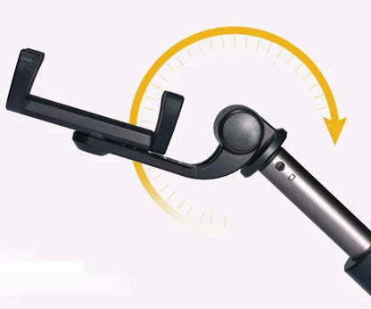 Black aluminium Bluetooth selfie stick with tripod legs extended, holding a mobile phone.