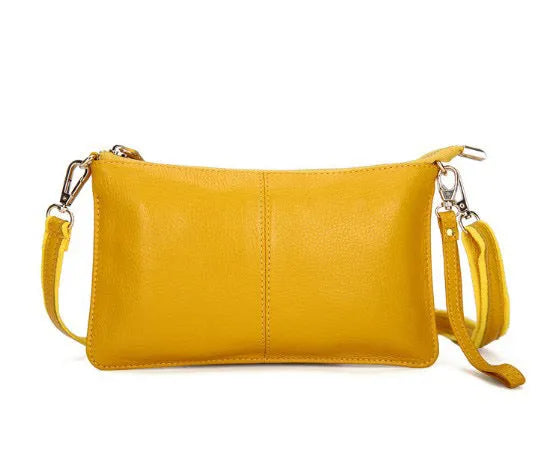 Lady's cowhide slant bag in apricot colour showing front view with strap and compact 24 cm size.