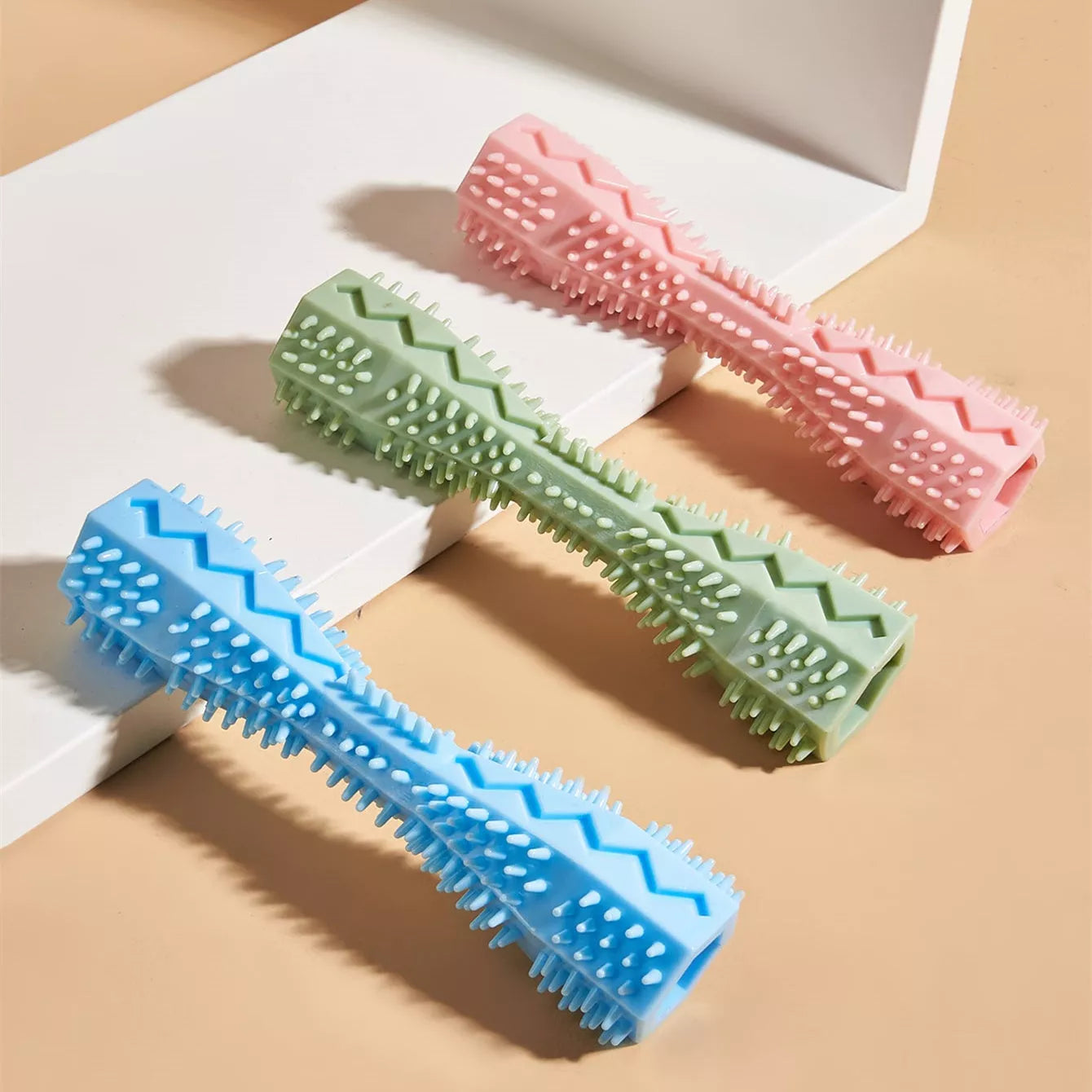 Hexagonal TPR chew toy for dogs in green, blue, or pink for teeth cleaning and anxiety relief