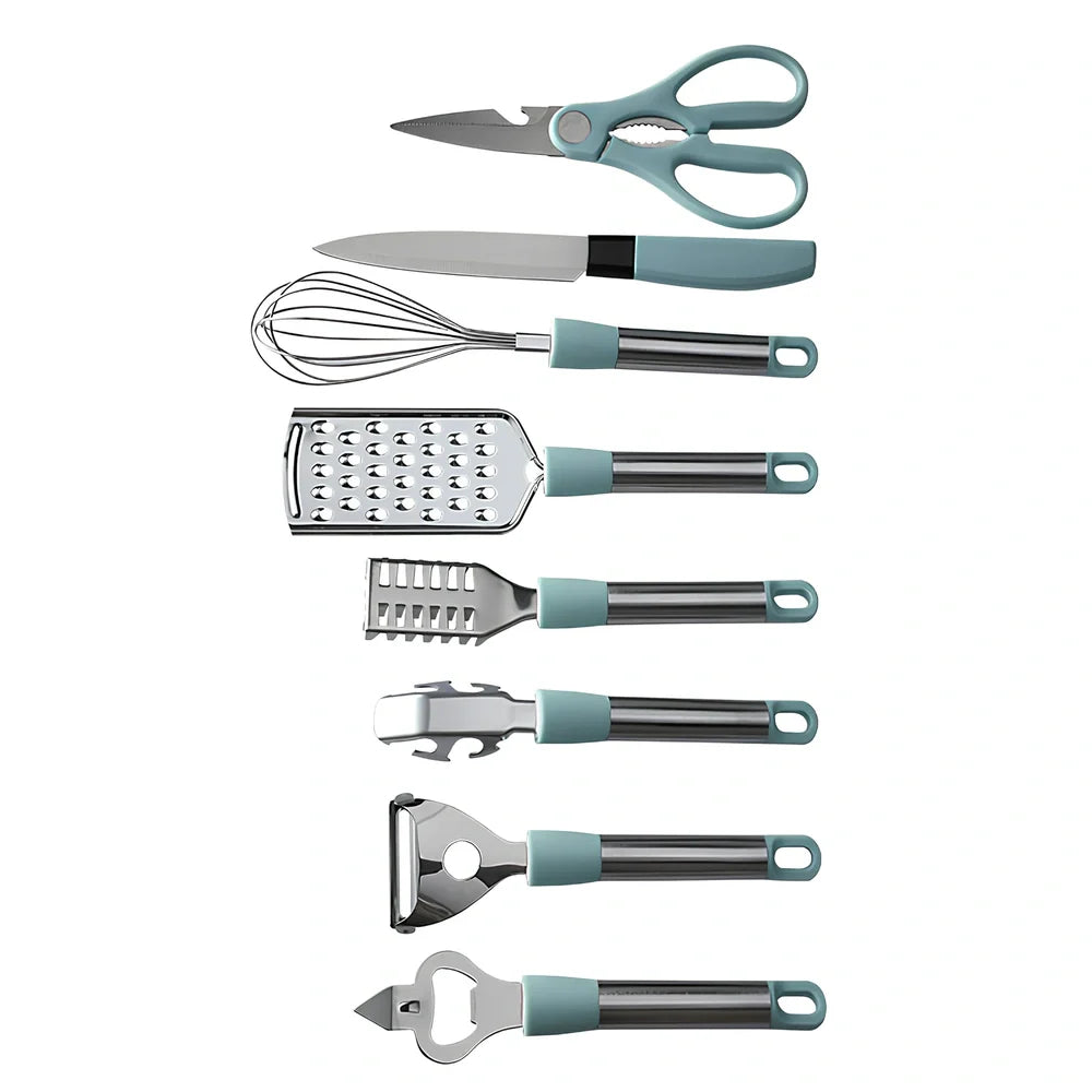 Stainless steel kitchen utensil set with whisk, grater, peeler, scissors and other tools on grey background