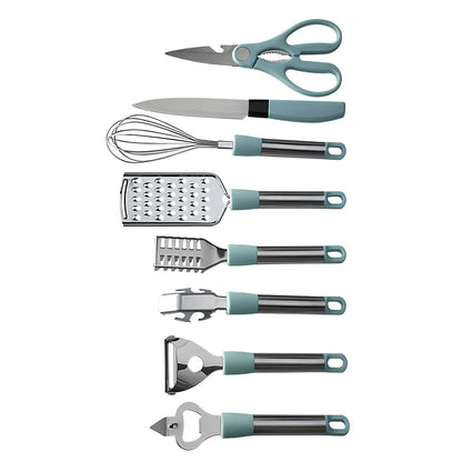 Stainless steel kitchen utensil set with whisk, grater, peeler, scissors and other tools on grey background