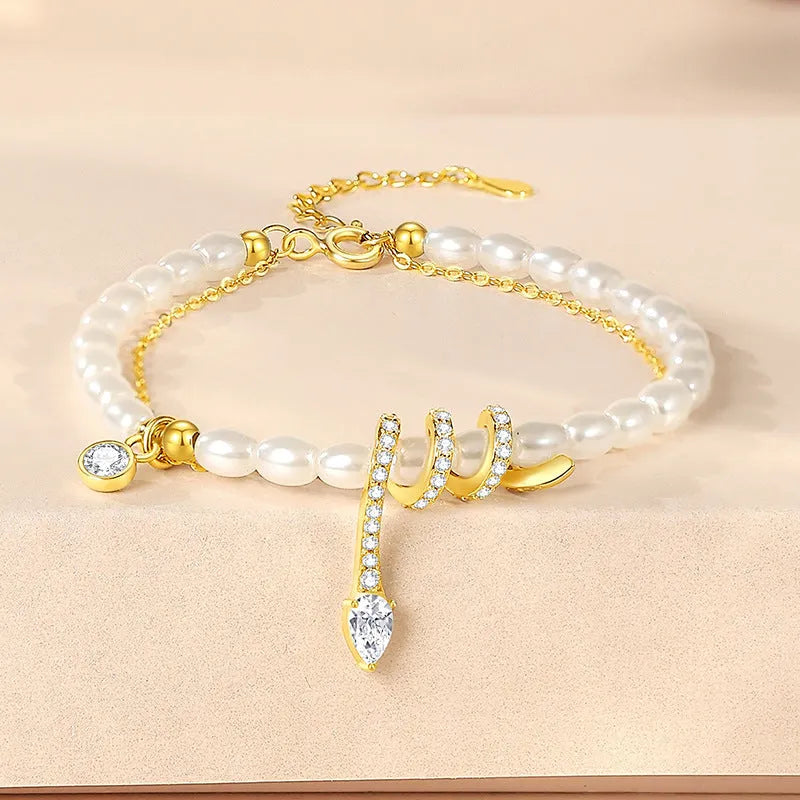 Pearl snake bracelet in 925 silver with electroplated gold or white gold finish and geometric animal design