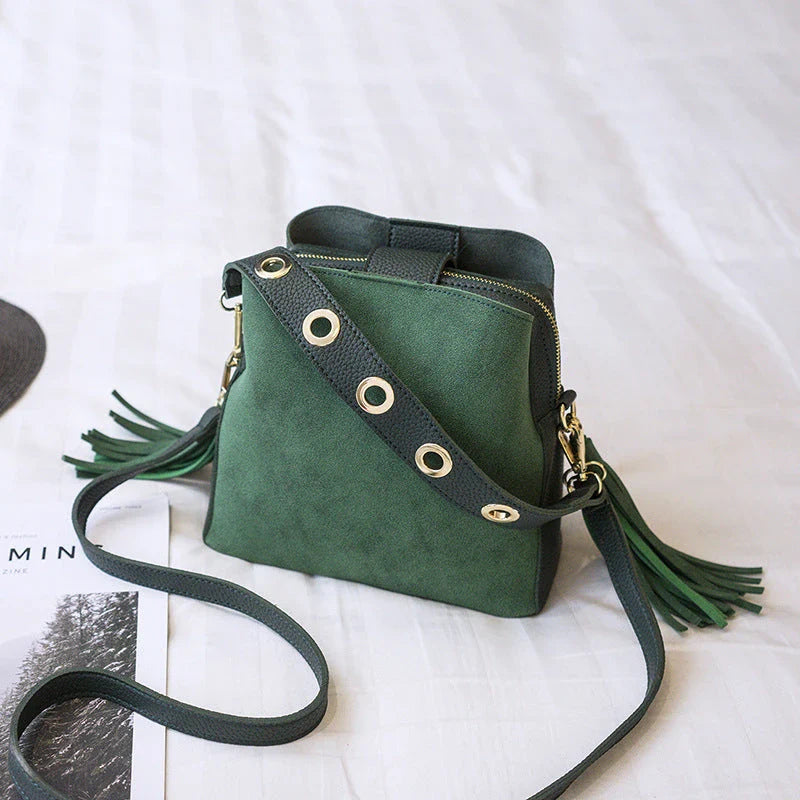 A stylish frosted tassel bucket bag with interior pockets and a versatile shoulder strap design