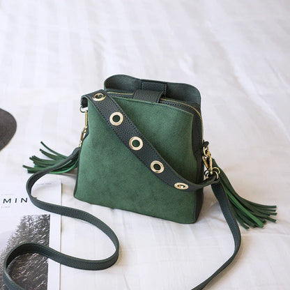 A stylish frosted tassel bucket bag with interior pockets and a versatile shoulder strap design