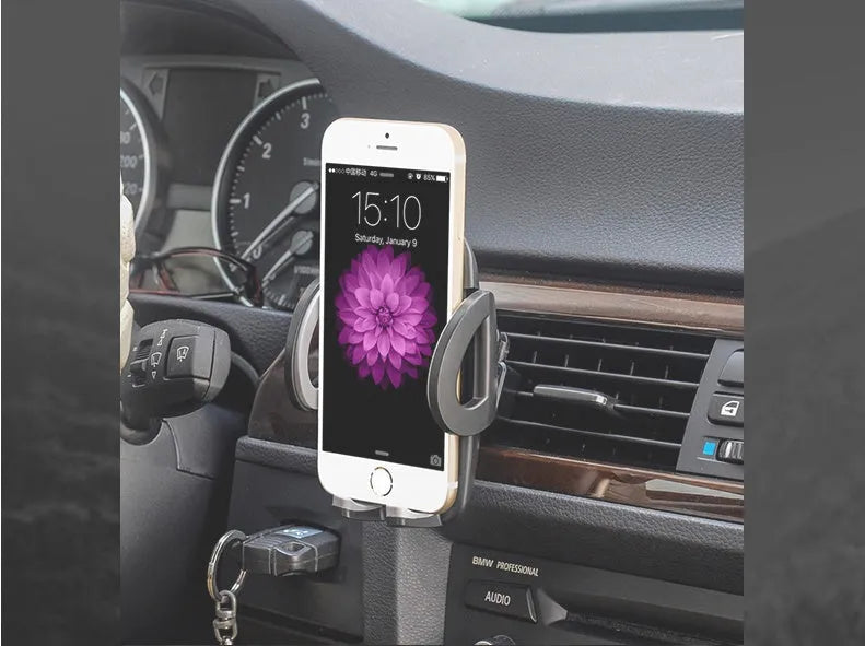 Black plastic mobile phone holder attached to a car air conditioning vent.