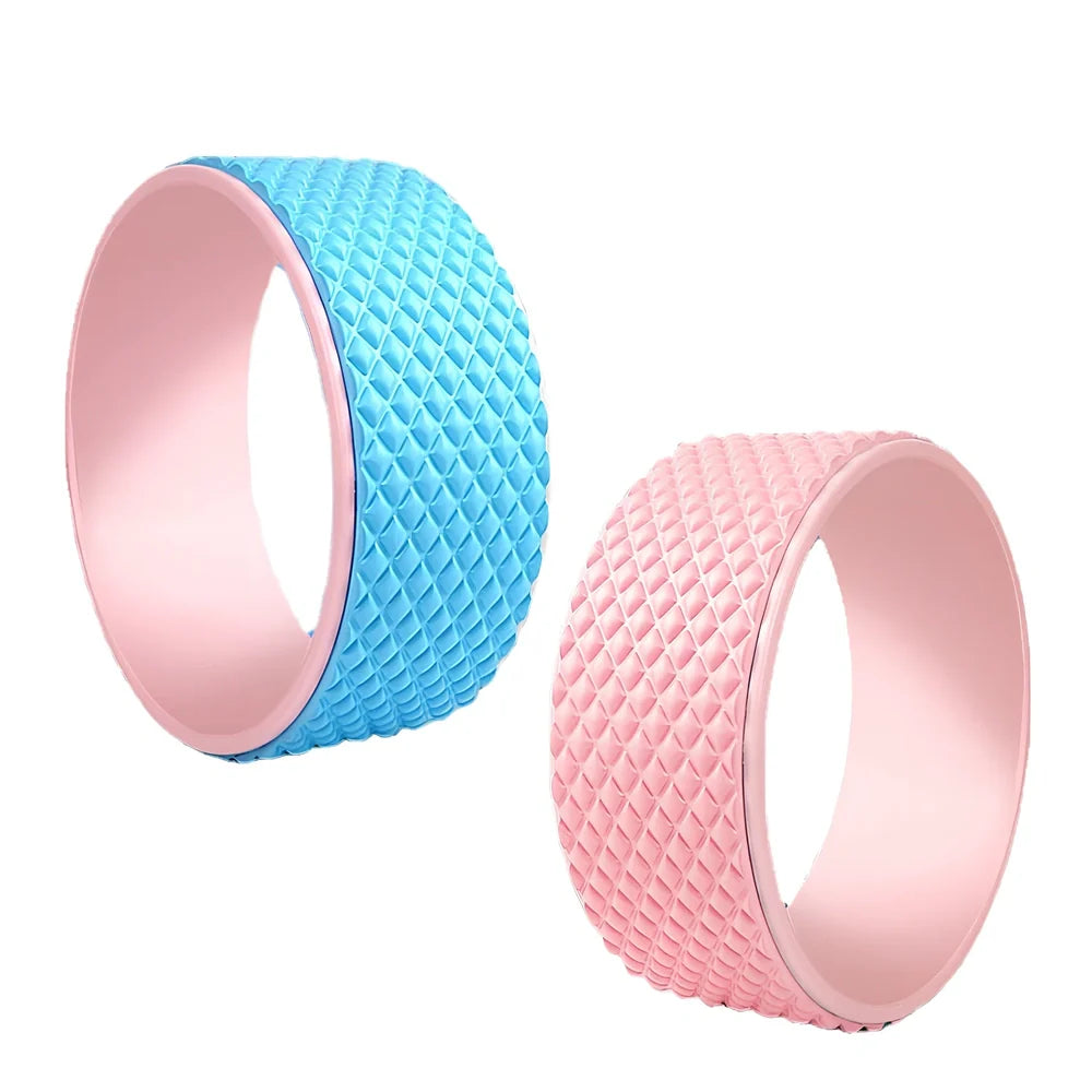 Pink yoga wheel with 31.5cm diameter and 12.2cm width for back-bending exercises