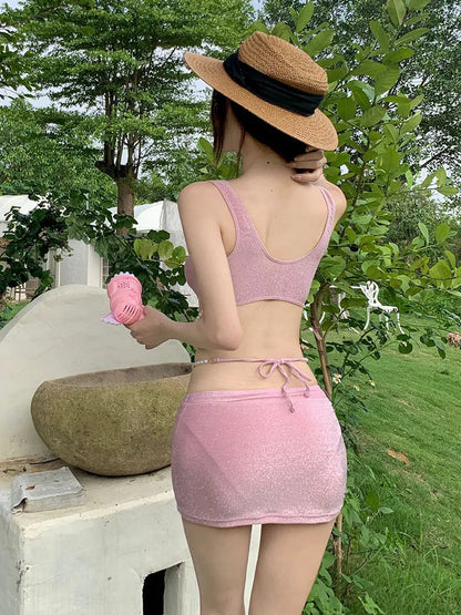 Pink and black three-piece bikini set with briefs style and sleeveless design for swimming.