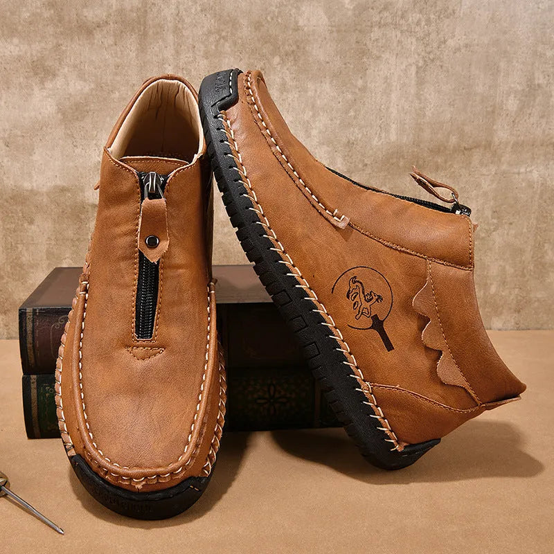 Men's slip-on loafers in black with round toe and sewing thread details, showing rubber sole