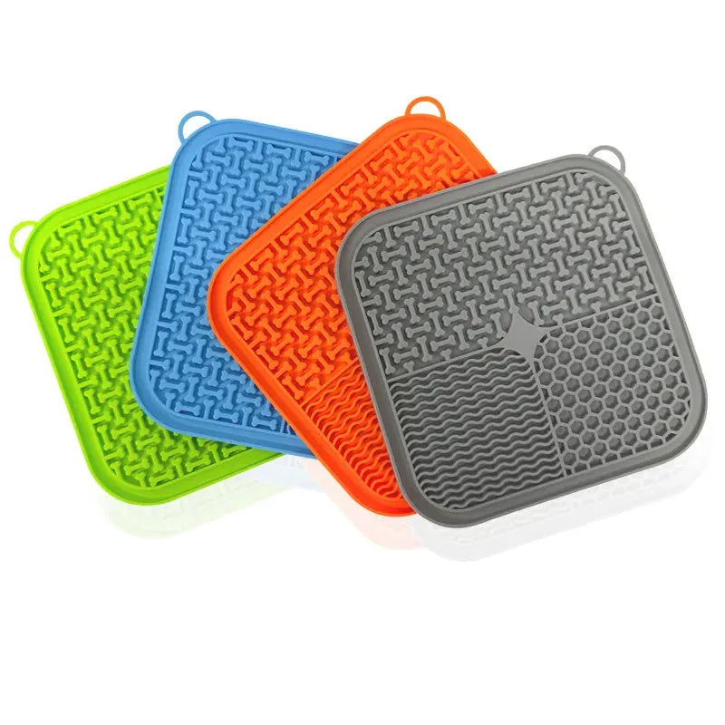 Orange, grey, blue, and green silicone dog licking mat with textured surface and suction cups