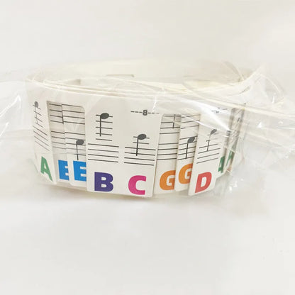 Piano keyboard stickers for 88-key pianos showing white card staff notation with colour bars and black notes