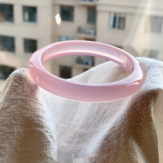 Natural agate wide tyre bracelet showing the stone's colour and the band's solid design on a wrist.