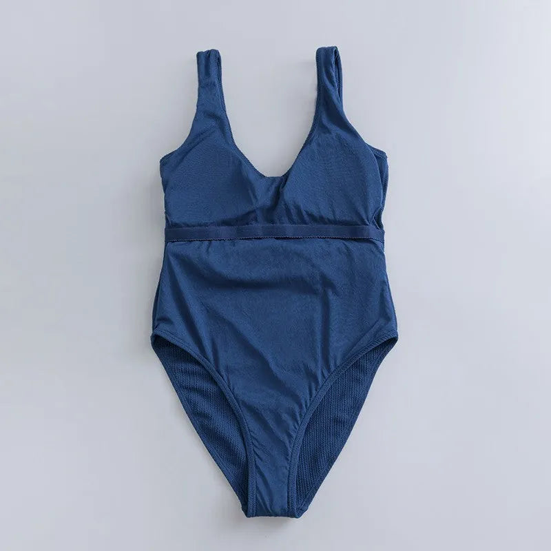 Navy blue women's one-piece swimsuit with triangle top and built-in chest pads for swimming