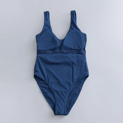 Navy blue women's one-piece swimsuit with triangle top and built-in chest pads for swimming