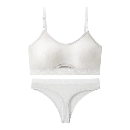 White sports bra and briefs set with thin moulded cups and double shoulder straps on a grey background.