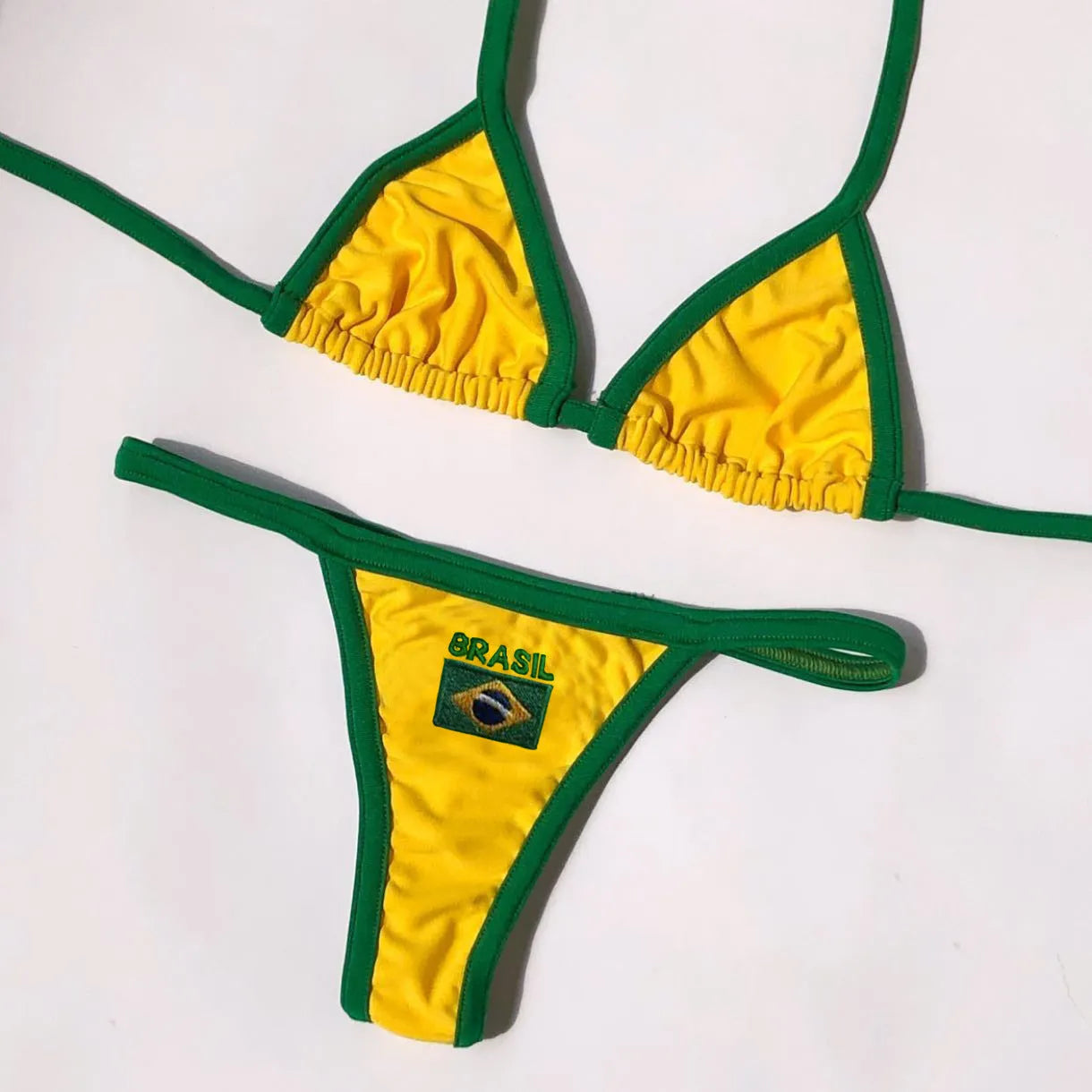 Women's slim fit T-back bikini set in blue, green, or yellow with shorts-length pants.
