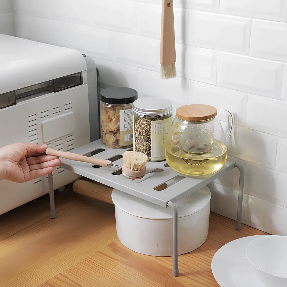 Grey retractable kitchen shelf with hollow grid design extended to 45cm width