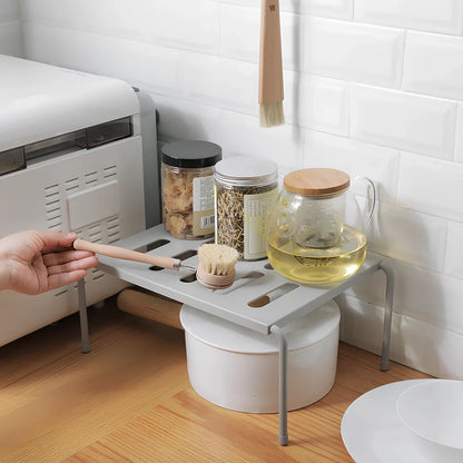 Grey retractable kitchen shelf with hollow grid design extended to 45cm width