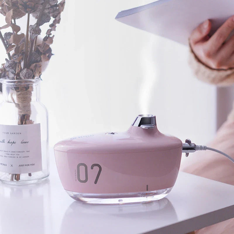Compact, USB-powered portable air humidifier with discreet night light and silent operation for improved air quality and comfort