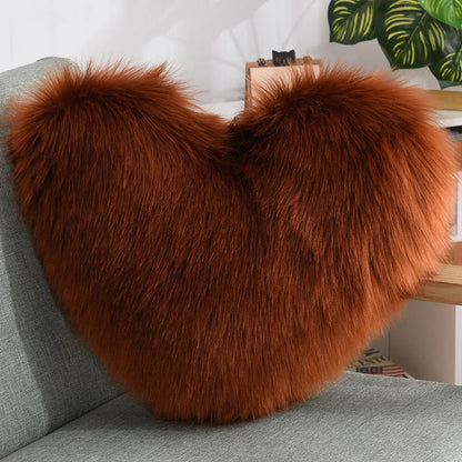 Cozy heart-shaped plush throw pillows in various colors and sizes for living room and bedroom decor