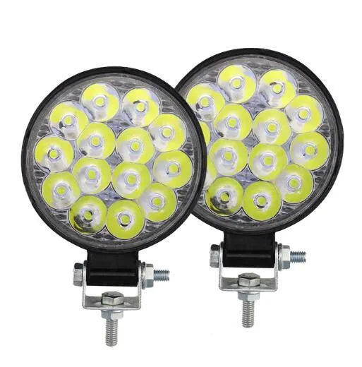 Small round white aluminium LED work light with IP67 rating for automotive use.
