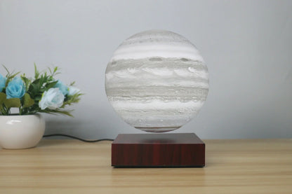 Levitating Earth or Jupiter lamp floating above base with LED illumination