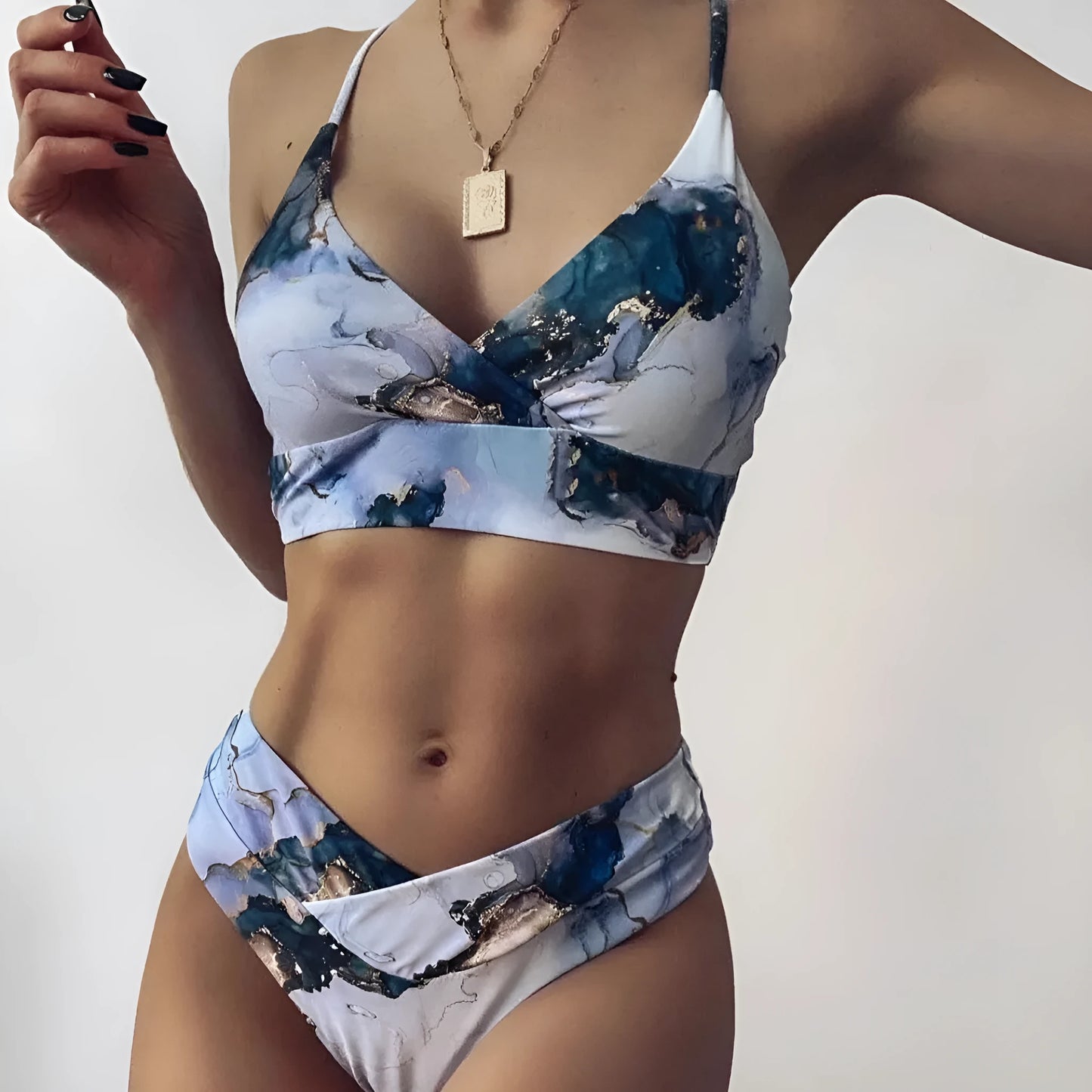 Women's high-waist bikini set with U-neck top in a blue marble tie-dye print.