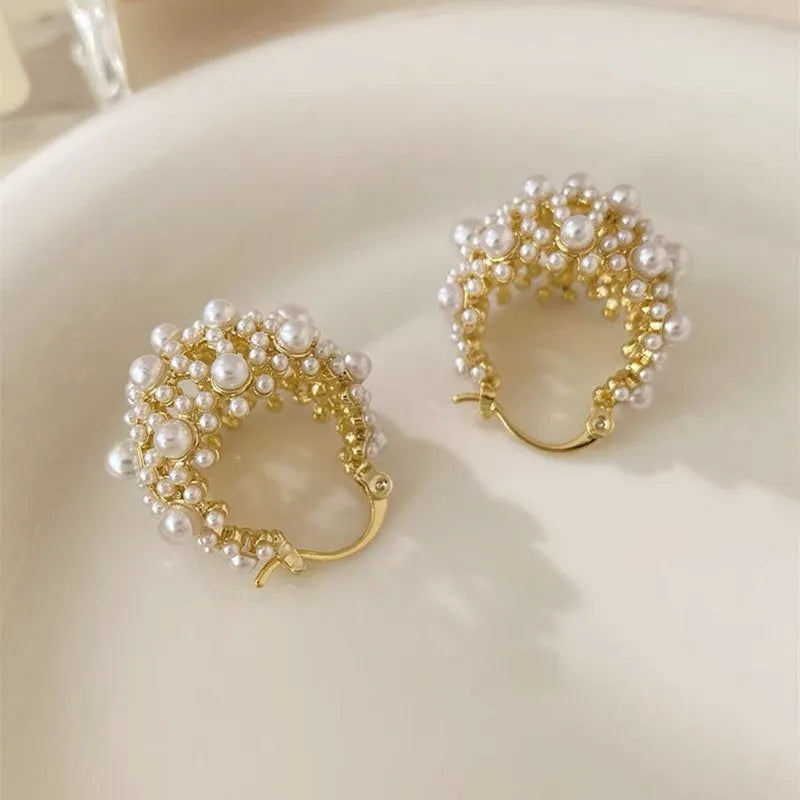 Gold-colour copper flower basket earrings with small rice-shaped bead inlay detail.